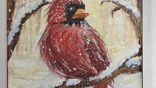 painting of bright red cardinal sitting on a snowy tree branch